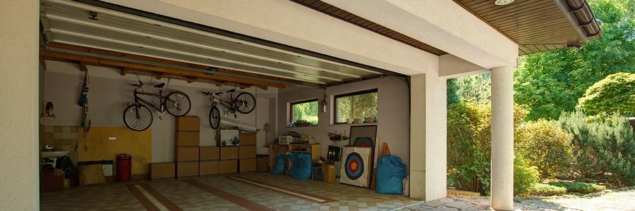 garage with bikes and boxes with door open
